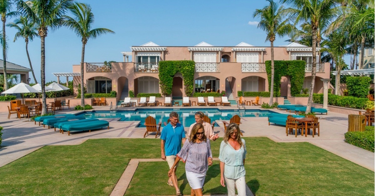 Members walking near the pool terrace at Orchid Island Country Club