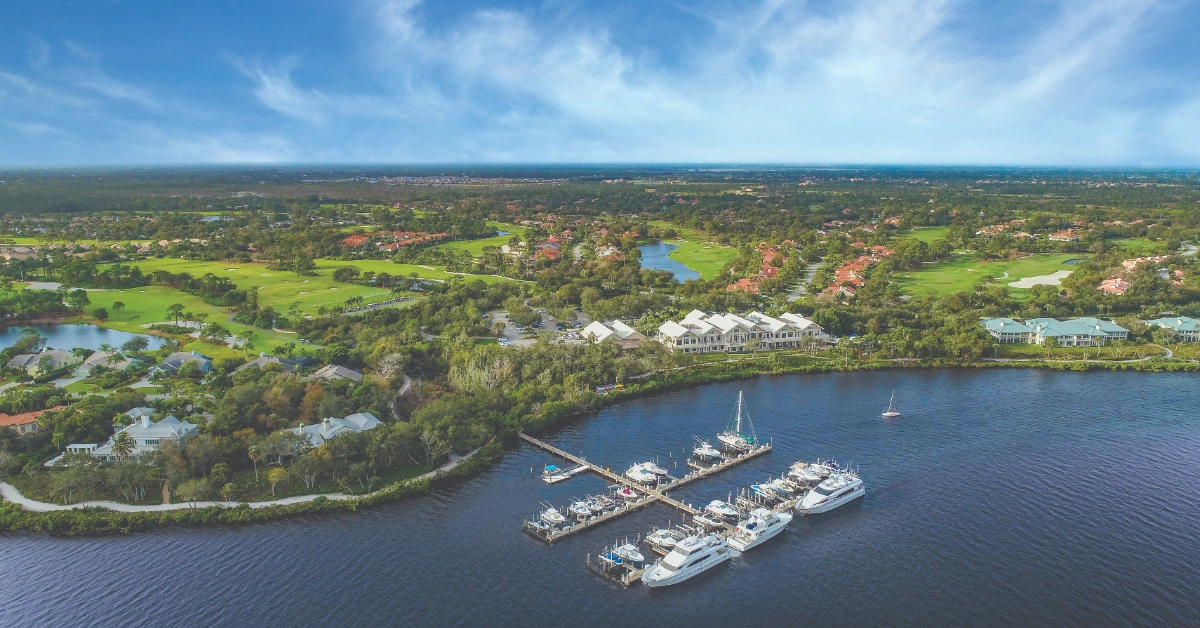 Aerial view of marina with boats and private docks along waterfront