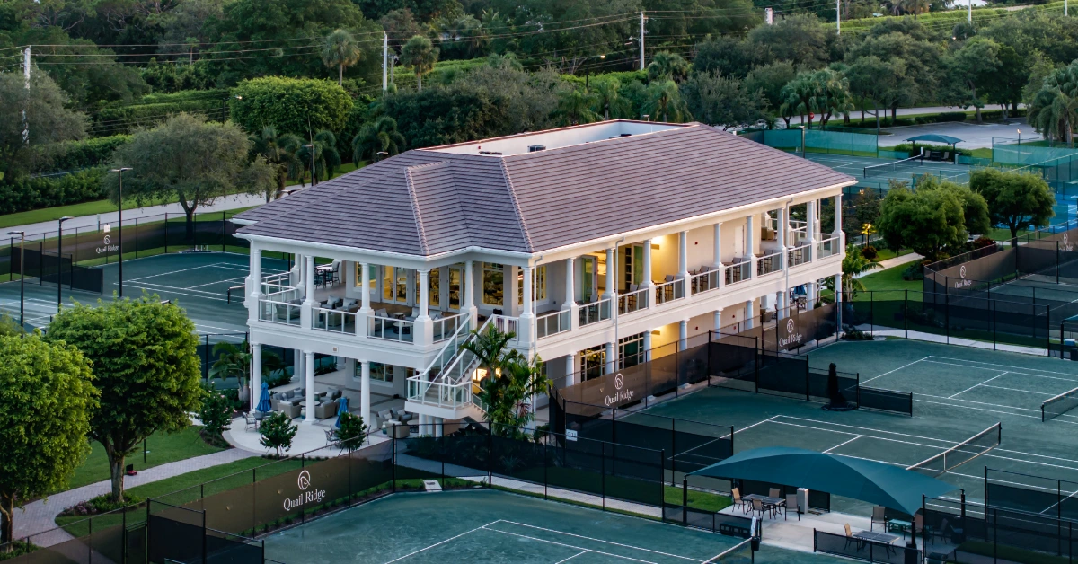 Aerial view of tennis courts and clubhouse at private country club