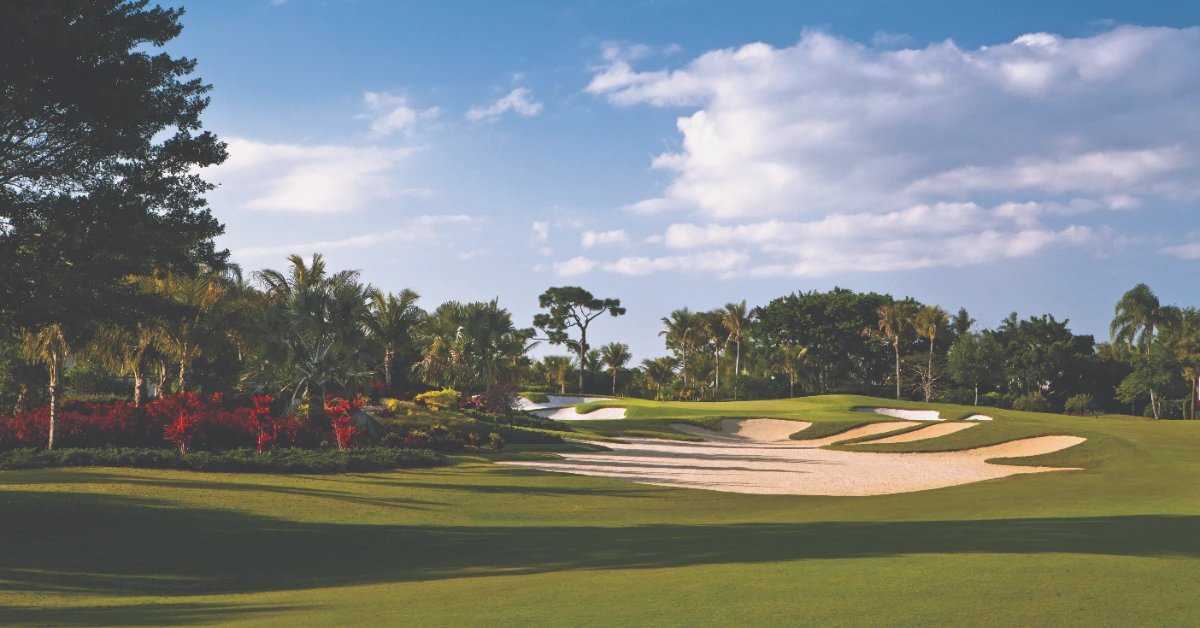 Golf course fairway with bunkers and tropical landscaping