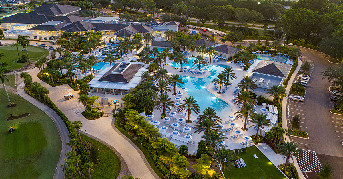 Aerial view of large resort style aquatics center with pools and palm trees